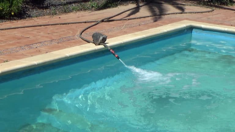 vacuuming a pool to waste