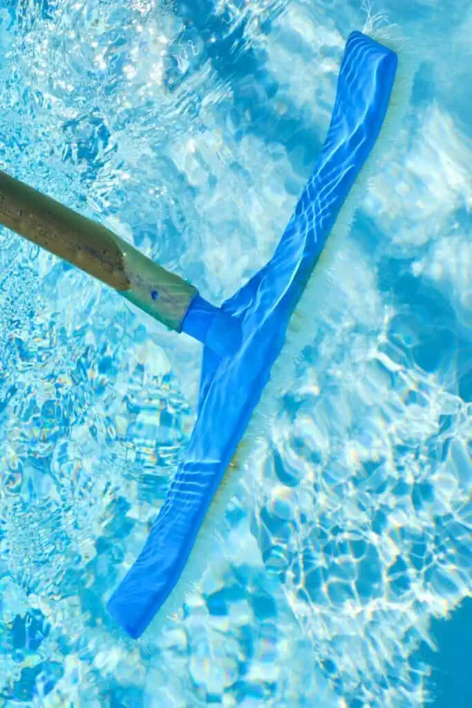 The pool walls and floor are being brushed to maintain cleanliness and hygiene