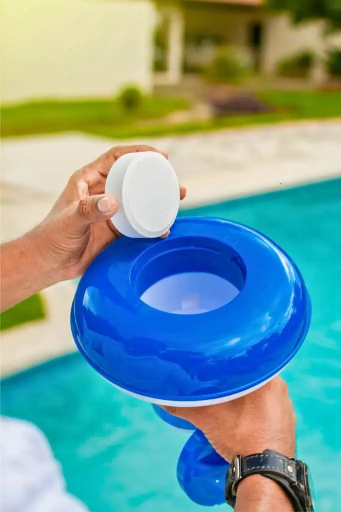 A pool with a chlorine flotaer being loaded and sparkling water in the background