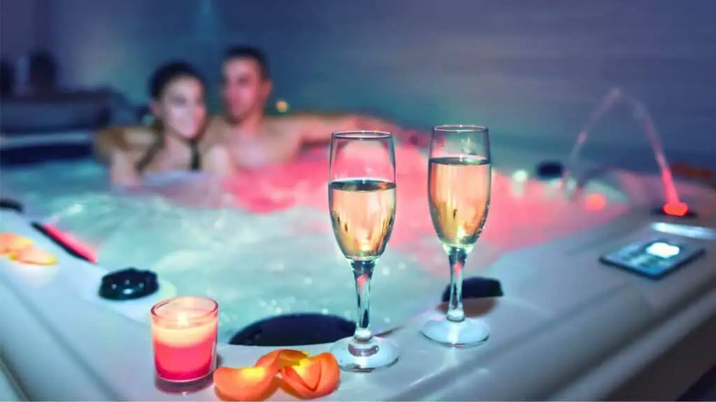 Coule relaxing in a hot tub with champagne